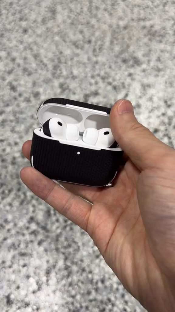 AirPods Pro 3 charging case with a black carbon skin